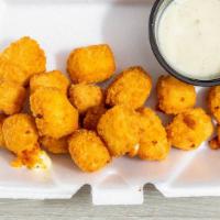 Cheese Curds · Deep-fried cheese curds served with a side of ranch or barbecue sauce.