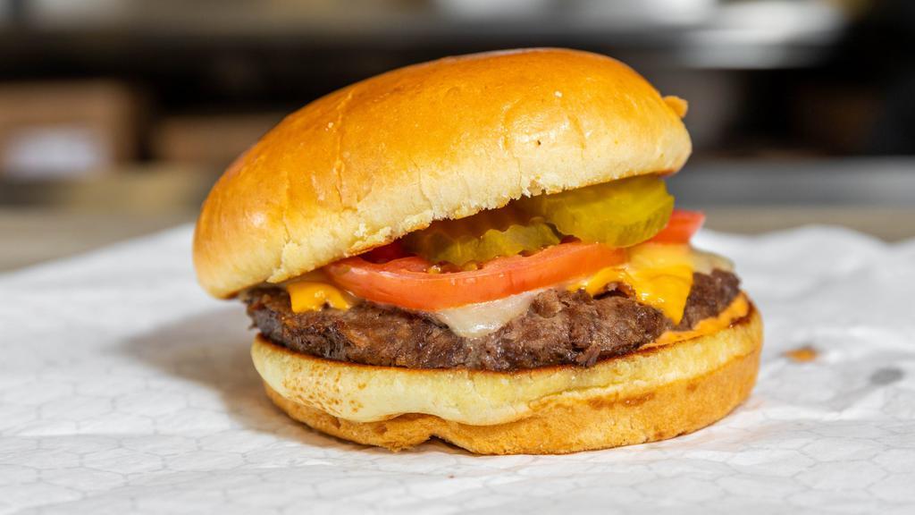 Happy Cow Impossible Burger · Tomatoes, ketchup, mustard, pickles, onions, and American cheese.