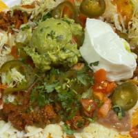 Nachos · With meat, guacamole and jalapeños, beans, lettuce, tomatoes, cilantro and sour cream.