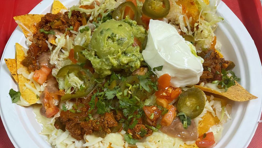 Nachos · With meat, guacamole and jalapeños, beans, lettuce, tomatoes, cilantro and sour cream.