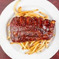 Bbq Rib Dinner · Tender baby back pork ribs dry rubbed and slow roasted. Smothered in our BBQ sauce and serve...