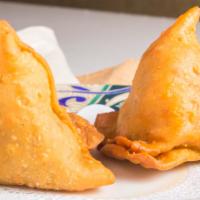 Samosa (2 Pieces) · Vegan. A fried pastry stuffed with potatoes and green peas.