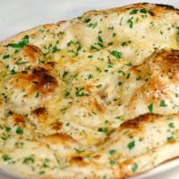 Garlic Naan · White flour bread topped and baked with finely chopped garlic and coriander leaves.