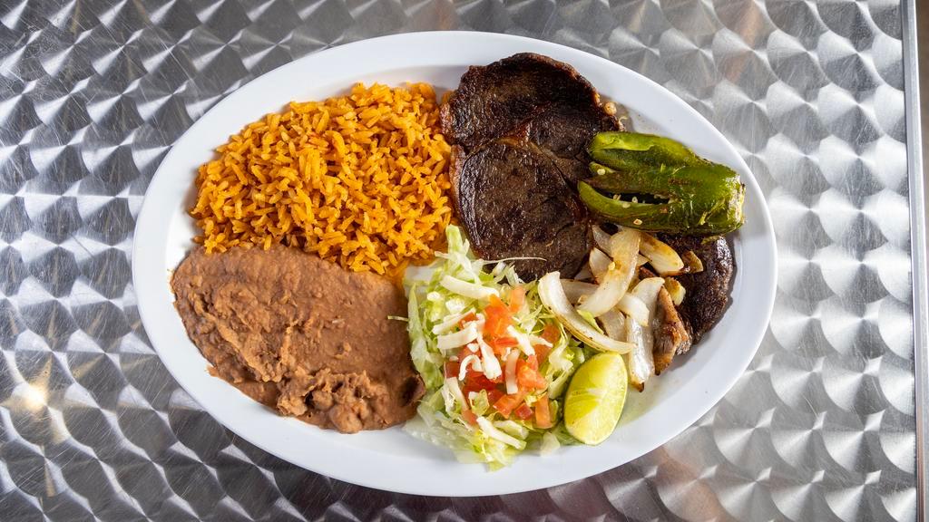 Carne Asada · Fresh u. S. Prime steak marinated and grilled to perfection. Steak with salad, grilled jalapeno and onions. Served with rice and beans.