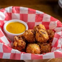 Pretzel Bites · Cheddar cheese stuffed pretzel bites. Comes with a side of Bourbon Mustard.