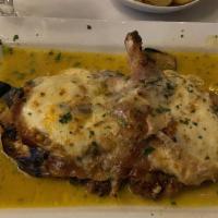 The Coach · Butterflied pork chop lightly breaded with grilled eggplant, prosciutto di Parma and fresh m...