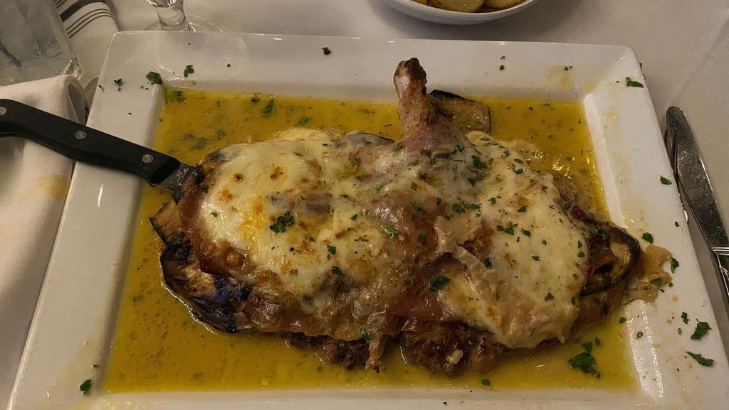 The Coach · Butterflied pork chop lightly breaded with grilled eggplant, prosciutto di Parma and fresh mozzarella cheese in a light lemon white wine sauce.