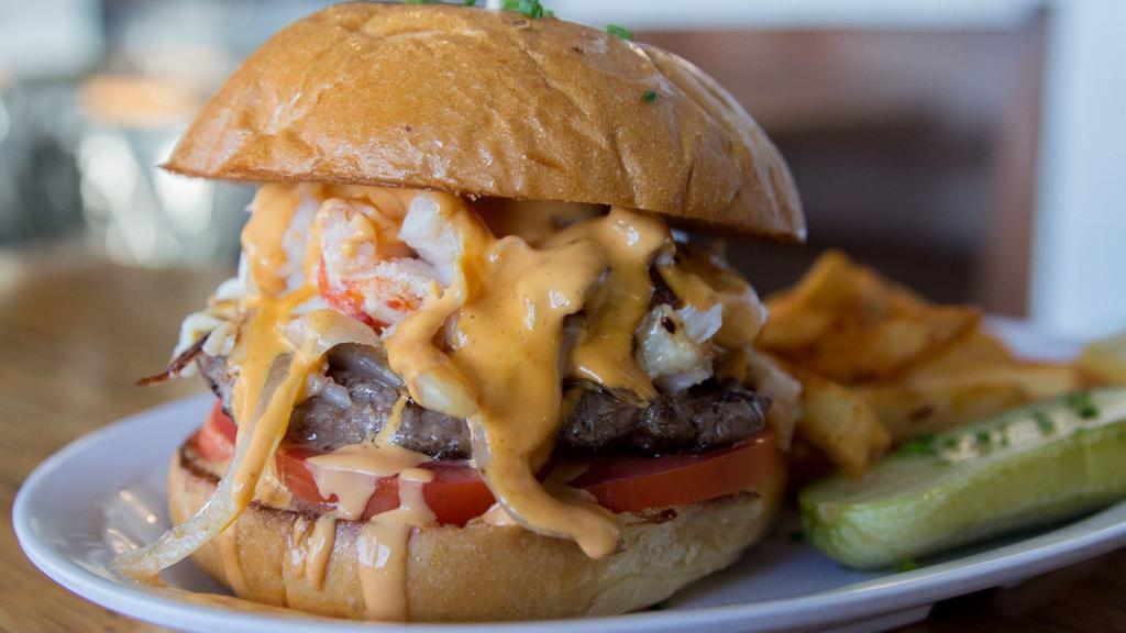 Surf N Turf Burger · Griddled beef patty smothered in lobster, crab, mozzarella cheese, creamy caramelized onion, tomato, and awesome sauce