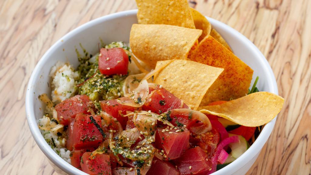 Poke Bowl · Only the freshest tuna poke, served on herb-seasoned rice, fresh greens, and chips