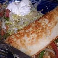 Quesadilla Rellena · A flour tortilla grilled and stuffed with cheese, chopped beef and refried beans. Served wit...