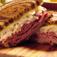 Corned Beef Reuben · Corned beef with tangy sauerkraut, Swiss cheese & 1000 island dressing on thick cut grilled ...
