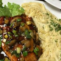 Bourbon Salmon · Fresh Salmon filet covered in our sweet jack daniels bourbon sauce and topped with scallions...