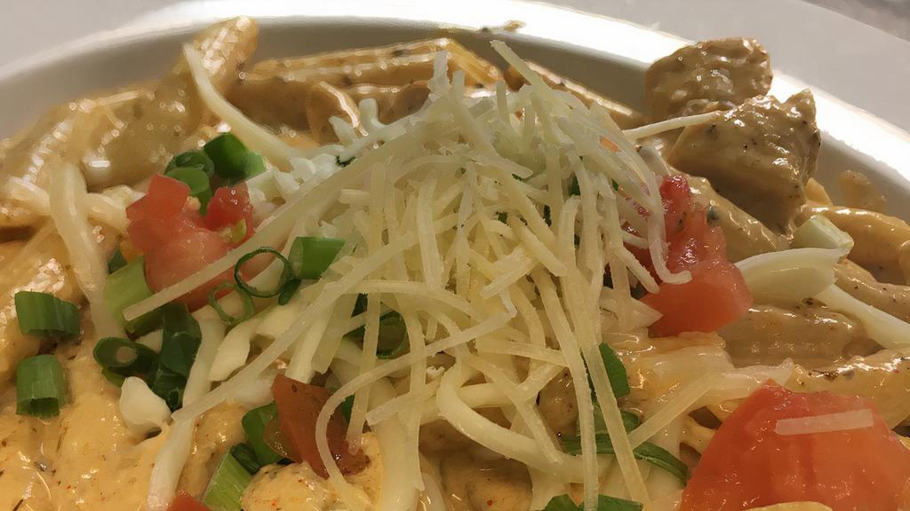 Santa Fe Chkn Pasta · Pasta and chicken sauteed in a lightly spiced cajun cream sauce and topped with tomatoes, mozzarella cheese and scallions