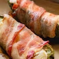 Jalapeno Poppers · Fresh, bacon-wrapped jalapeño stuffed with onion and chive cream cheese.