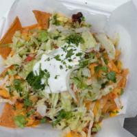 Jerky Nachos · Topped w/ Grilled Chicken Cheese, Jerk Sauce, Sour Cream, Lettuce & Onion.