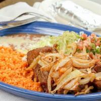 Carnitas Dinner · Tender chunks of fried pork with sautéed onions served with rice, beans, lettuce, guacamole,...