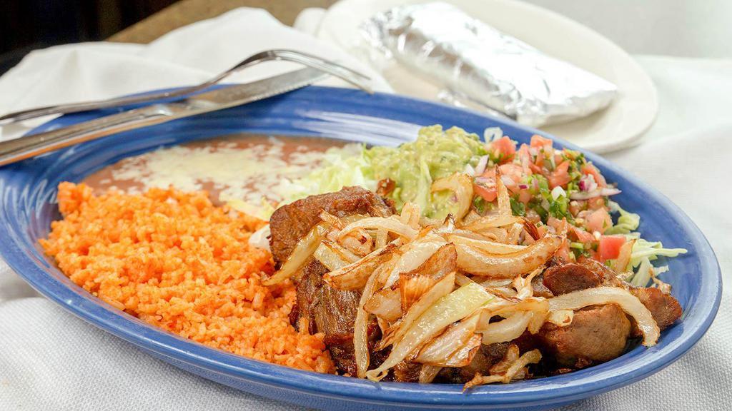 Carnitas Dinner · Tender chunks of fried pork with sautéed onions served with rice, beans, lettuce, guacamole, pico de gallo and three tortillas.