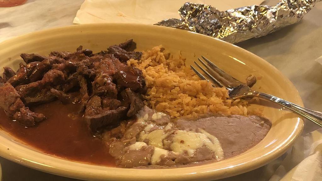 Chili Colorado · Grilled steak strips with red sauce served with rice, beans, three tortillas and your choice of guacamole salad or tossed salad.