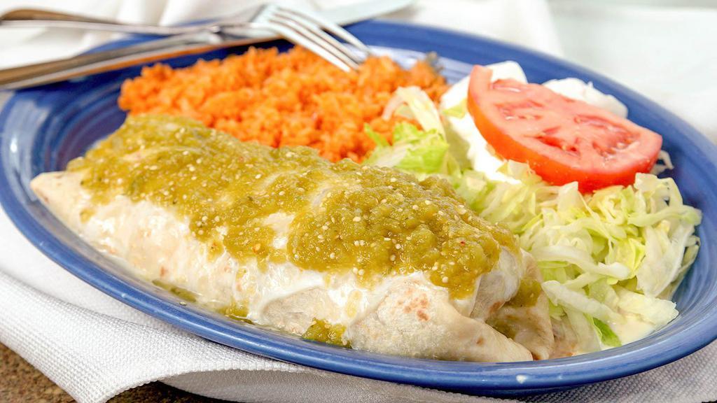 Burrito Verde · A grande burrito filled with grilled chicken, onion, tomatoes and peppers, covered with cheese sauce and green tomatillo sauce. Served with rice, lettuce, sour cream and tomato.
