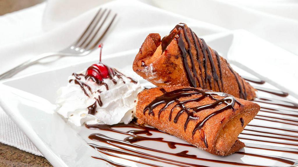 Xango (Pronounced Chang-O) · Creamy cheesecake wrapped in a pastry tortilla, fried until flaky and golden and dusted with cinnamon sugar, with choice of topping.