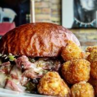 Corned Beef · Caramelized sprouts and a side of Uncle Pete's mustard with Swiss cheese on a pretzel bun.