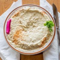 Baba Ganoush Half · Char-garlic eggplant blended with tahini sauce, lemon juice, and garlic. Top it with a littl...