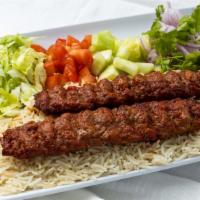 Adana Kabob Plate · Ground lamb slightly seasoned and cooked on a skewer served with rice and salad.