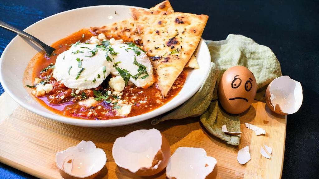 Eggs In Purgatory · soft poached eggs in a spicy, rich tomato sauce with roasted red peppers, spinach, kalamata olives, and feta served with toasted flatbread