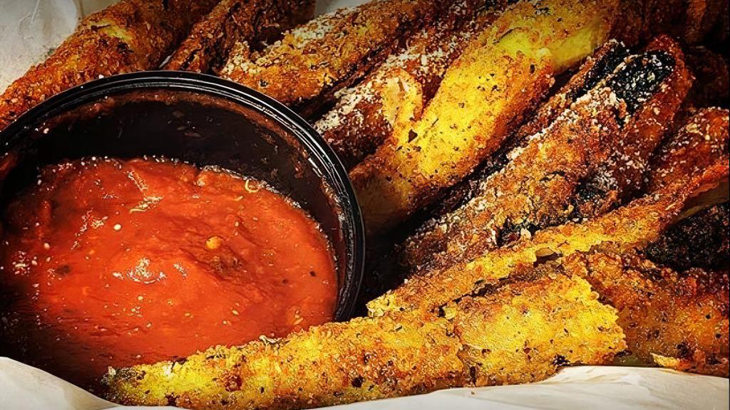 Sweet Potato Chips · Giant bowl of sweet potato chips with a side of chipotle sauce.