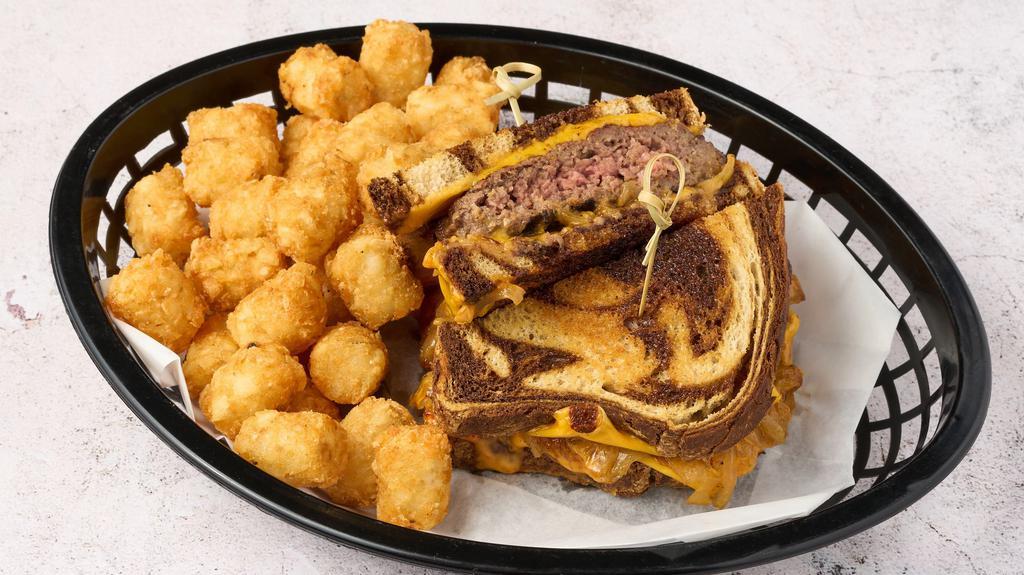 Patty Melt · Topped with grilled onions, American cheese, and house sauce, on rye bread, and side choice of fries or tots.
