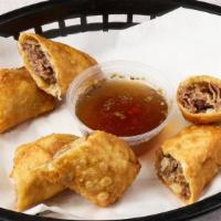 Beef Egg Rolls · Three fried rolls filled Italian beef and giardiniera served with a side of au jus.