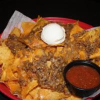 Lots-O-Nachos · Crispy chips topped with chicken or beef, smothered with shredded cheese, Rotel cheese sauce...