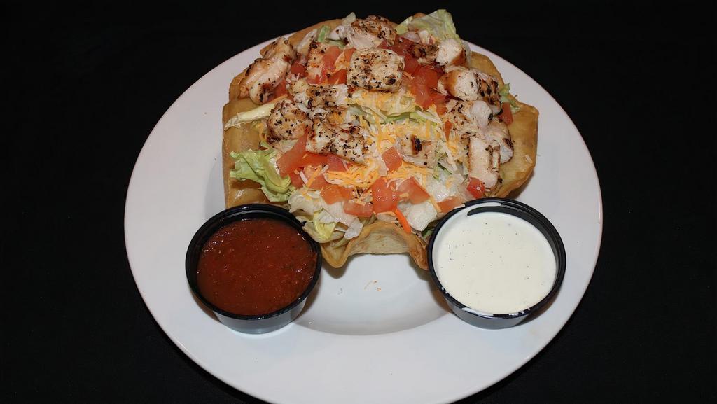 Taco Salad · Fried flour tortilla shell filled with seasoned chicken or beef, iceberg lettuce, tomatoes, sour cream & salsa.