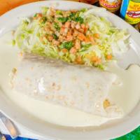 Wet Burrito · A large flour tortilla filled with grilled chicken, shrimp, and rice. Smothered in cheese sa...