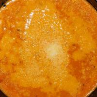 Traditional Tomato Soup · Traditional tomato soup topped with parmesan.