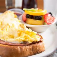 Monte Cristo Breakfast · Two pieces of our homemade french toast topped with a slice of ham and scrambled eggs* with ...