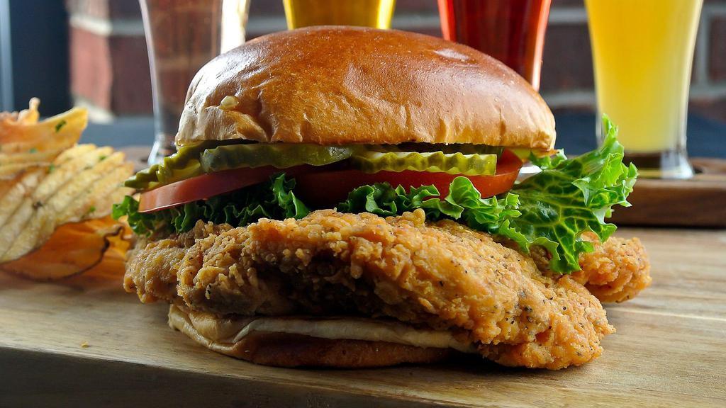 Crispy Chicken Sandwich · Hand-breaded and fried chicken breast with lettuce, tomato, crinkle cut pickle slices and Sriracha mayo on a grilled brioche bun
