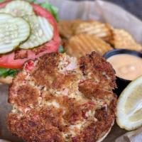 Housemade Crab Cake Sandwich · A crispy cake with lettuce and tomato topped with a tangy bistro sauce and served on a grill...