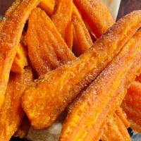 Sweet Potato Fries · Thick wedge-cut sweet potatoes fried golden and seasoned with our special blend of sea salt ...