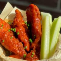 Buffalo Chicken Tenders · Golden fried chicken strips buffalo style served with celery sticks and bleu cheese.