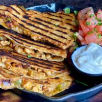 Chicken And Cheese Quesadilla · Grilled chicken breast, green peppers and onions smothered with our house cheese blend and c...