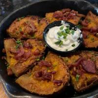 Loaded Bacon & Cheddar Potato Skins · Freshly cut potato skins loaded with crumbles of crisp bacon and melted cheddar cheese