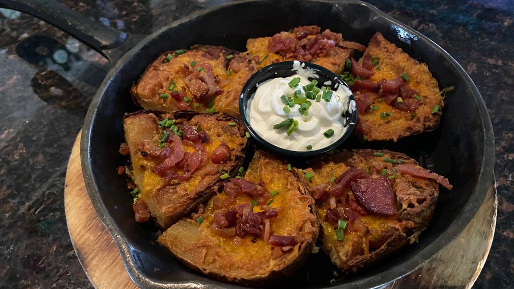 Loaded Bacon & Cheddar Potato Skins · Freshly cut potato skins loaded with crumbles of crisp bacon and melted cheddar cheese