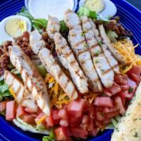 Signature Cobb Salad · Tender chunks of grilled chicken breast, crumbled bacon, shredded cheddar cheese, tomatoes a...