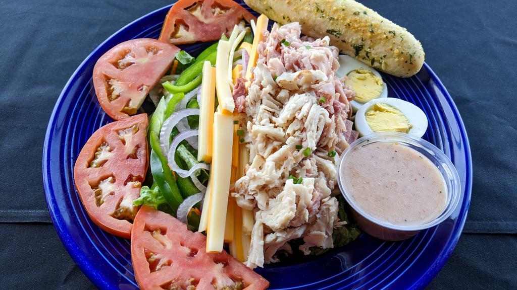 Julienne Salad · Julienne strips of turkey and Dearborn ham, Swiss and American cheeses, hard-boiled egg, tomatoes, red onions and cucumbers over mixed greens