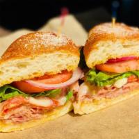 Famous Italian Grinder · This speciality grinder features Dearborn ham, pepperoni, house cheese blend, tomatoes, onio...