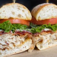 Turkey Club Grinder · Deli sliced turkey stacked with Applewood smoked bacon, house cheese blend, lettuce, tomatoe...