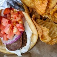 Traditional Greek Gyro · Thinly sliced gyro meat rolled together with red onions
and diced tomatoes. Topped with tzat...