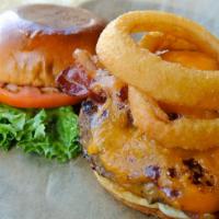 Texan Burger · Cheddar cheese, a crispy onion ring, Applewood smoked bacon and tangy BBQ sauce