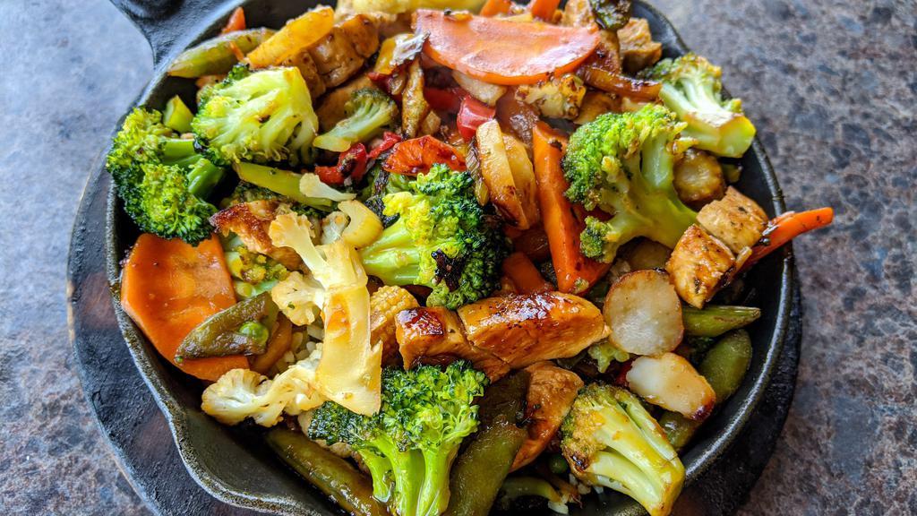 Chicken Stir Fry · Garden mix of fresh vegetables and seasoned chunks of chicken breast sautéed in a teriyaki sauce and served over a bed of wild rice